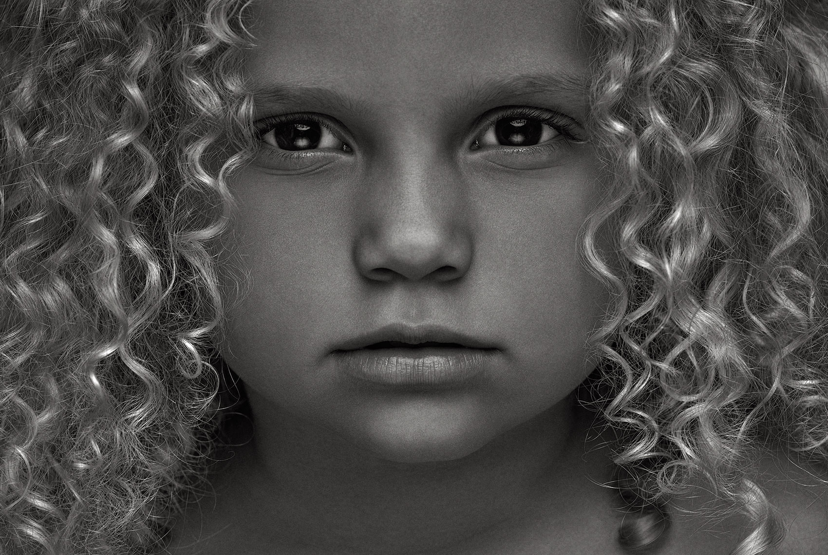 black and white portrait of young girl with curly hair